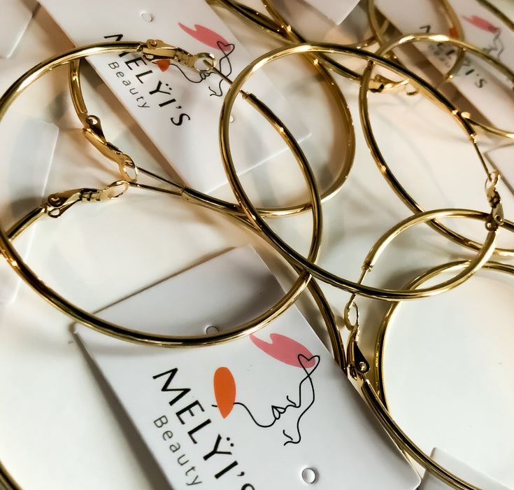 Mando Silver and Gold HoopsThese Mando Silver and Gold Hoops are the perfect go-to accessory for any daily outfit. Crafted with durable silver and gold finishes, these hoops will last through even the most active days. With their chic and timeless design,