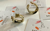 Gold Twisted CirclesThese striking gold twisted circles are the perfect addition to any outfit. Handcrafted from 925 sterling silver with a luxurious gold plating, these half hoop earrings feature an elegant twist for a statement look.Gold Twisted Circles