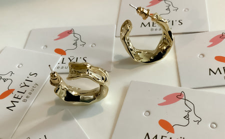 Gold Twisted CirclesThese striking gold twisted circles are the perfect addition to any outfit. Handcrafted from 925 sterling silver with a luxurious gold plating, these half hoop earrings feature an elegant twist for a statement look.Gold Twisted Circles