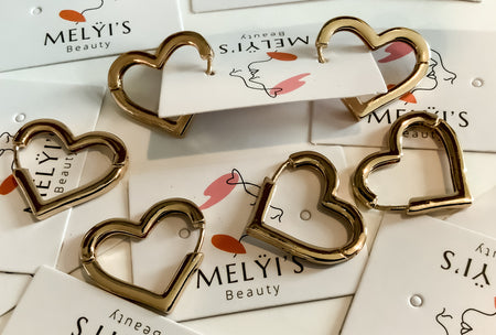 Golden Heart Shaped EarringsThese elegant golden heart shaped earrings are a perfect addition to any wardrobe. Held secure with snap clip lock technology, they are designed for comfort and long-lasting wear. Enjoy a subtle touch of beauty and glamour with