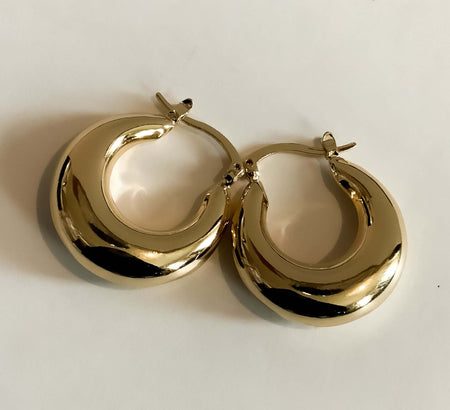 Chubby Gold HuggiesAdd a touch of sophistication to your everyday outfits with Chubby Gold Huggies. Crafted with high-quality gold metal, these elegant earrings will stay strong as a symbol of your style. Their slim profile and versatile design make them