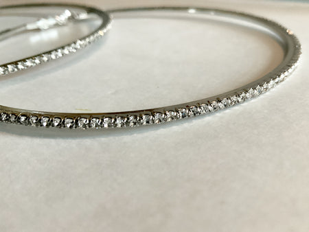 Silver and Gold Crystal HoopsThese classic Silver and Gold Crystal Hoops are the perfect accessory for any outfit. Intricately designed with shimmering crystals, they add a touch of elegance and sparkle. Crafted from durable materials, these hoops will la