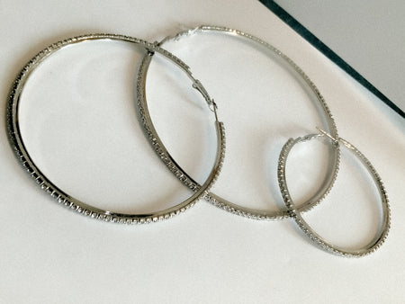 Silver and Gold Crystal HoopsThese classic Silver and Gold Crystal Hoops are the perfect accessory for any outfit. Intricately designed with shimmering crystals, they add a touch of elegance and sparkle. Crafted from durable materials, these hoops will la