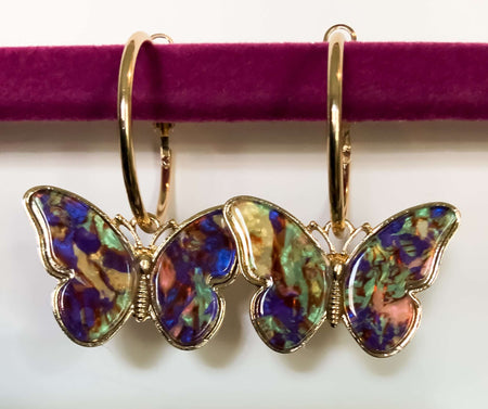 Gold Hoop ButterfliesThese beautiful Gold Hoop Butterfly earrings capture the beauty and vibrant colors of these majestic creatures. The multi-colored butterfy earrings are sure to bring a touch of nature's beauty to any outfit.Gold Hoop ButterfliesThese