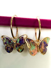 Gold Hoop ButterfliesThese beautiful Gold Hoop Butterfly earrings capture the beauty and vibrant colors of these majestic creatures. The multi-colored butterfy earrings are sure to bring a touch of nature's beauty to any outfit.Gold Hoop ButterfliesThese